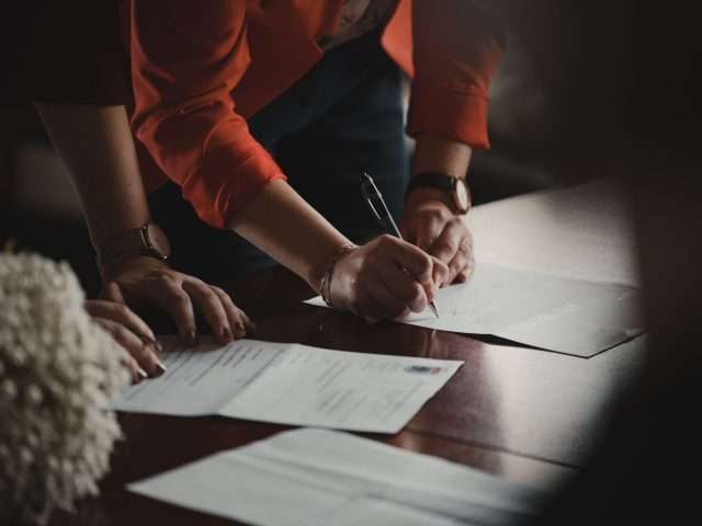woman signing papers